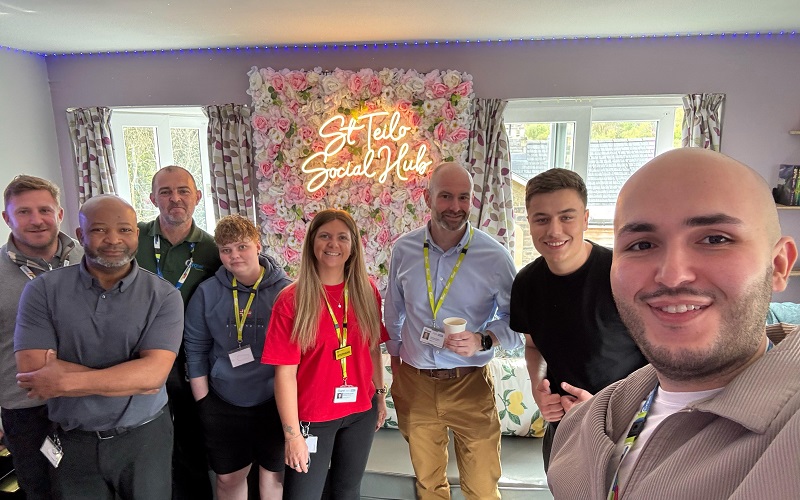 Staff celebrate the opening of the new social hub